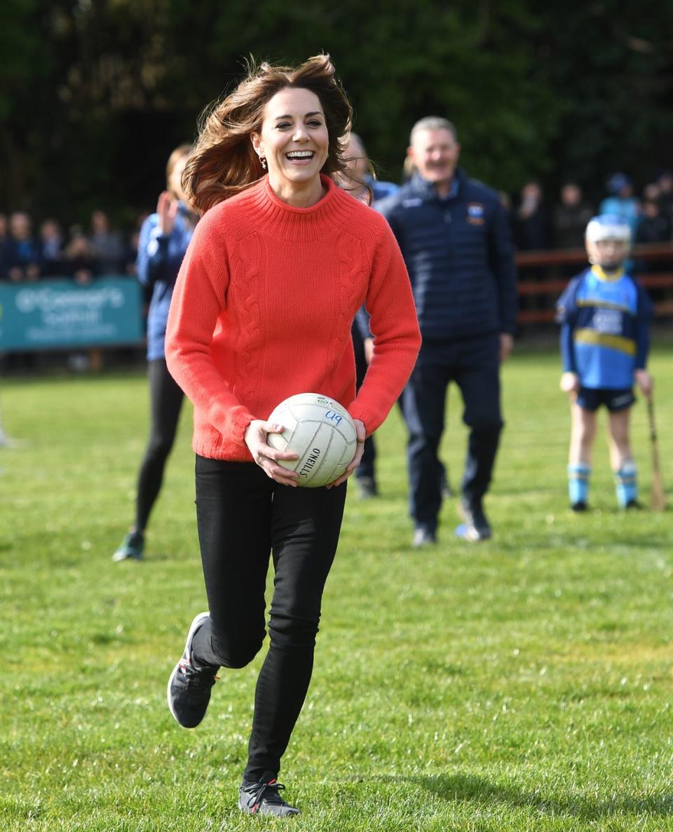 <p>Kate looked ecstatic playing Gaelic football with Irish children. </p>