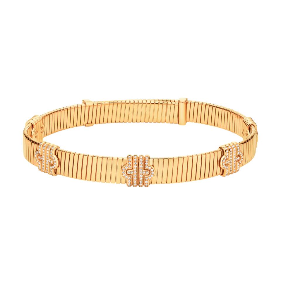 a wooden bracelet with a gold band