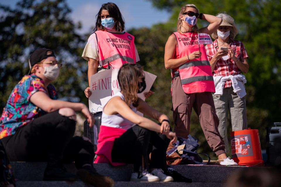 People gather during a demonstration at State Capitol in Nashville, Tenn., Monday, April 19, 2021. The demonstration was in opposition to a bill requiring women who receive a surgical abortion to bury fetal remains.