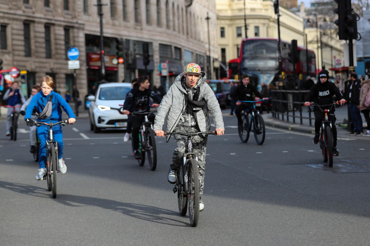 Cyclists take to the middle of the road and ride two-abreast in the street, as the new Highway Code rules start today together with giving pedestrians priority at junctions, at the junction of Trafalgar Square, in London, Britain, January 29, 2022. REUTERS/May James