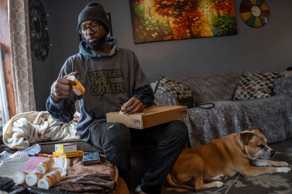 Tim Hawthorne, 51, of Gaylord, looks over medications that arrived in the mail for his son Trae, on Wednesday, March 27, 2024.