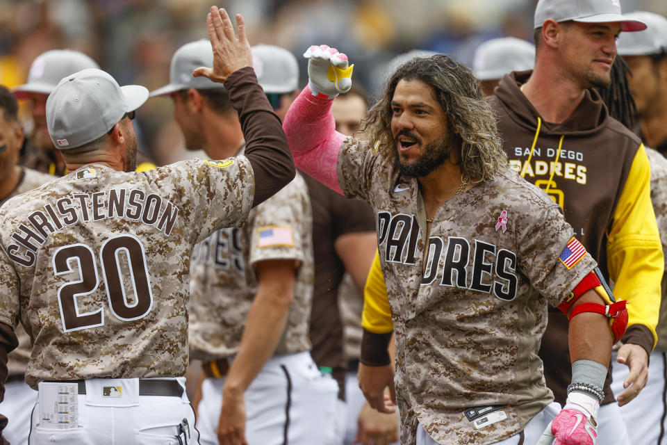 San Diego Padres' Jose Alfaro, front right, celebrates with bench coach Ryan Christenson after hitting a three-run walkoff home run against the Miami Marlins during the ninth inning of a baseball game Sunday, May 8, 2022, in San Diego. (AP Photo/Mike McGinnis)