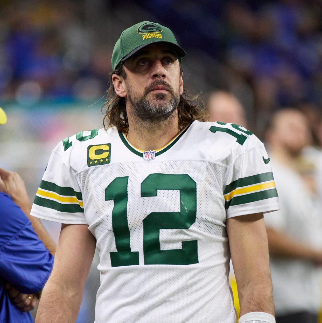 Aaron Rodgers looks up from the sideline during a game in 2022.