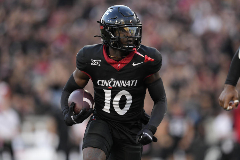 Cincinnati safety Bryon Threats (10) returns an interception during the first half of an NCAA college football game against Miami (Ohio), Saturday, Sept. 16, 2023, in Cincinnati. (AP Photo/Jeff Dean)