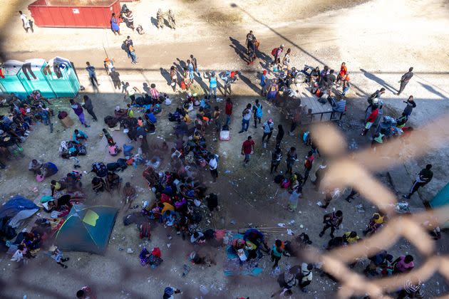 Migrants, mostly from Haiti, gather at a makeshift encampment under an overpass on the border between Del Rio, Texas, and Acuña, Mexico, on Sept. 17. (Photo: Jordan Vonderhaar via Getty Images)