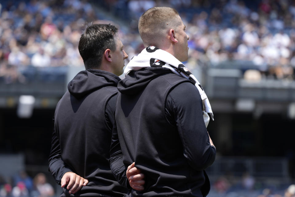 New York Yankees' Cody Poteet, left, and Ian Hamilton, right, stand after the national anthem before the first inning of a baseball game against the Cincinnati Reds, Thursday, July 4, 2024, in New York. (AP Photo/Pamela Smith)