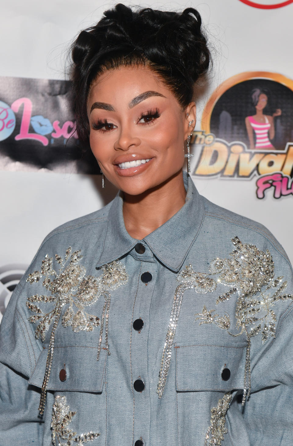 Close-up of Angela smiling and wearing bejeweled denim