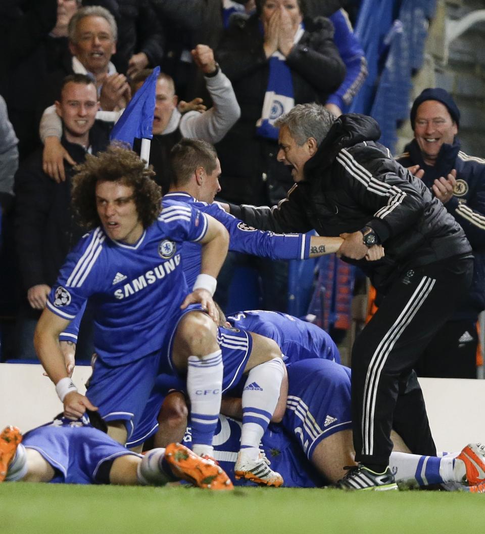 Chelsea's manager Jose Mourinho, right, celebrates with his team after Demba Ba scores the winning goal during the Champions League second leg quarterfinal soccer match between Chelsea and Paris Saint-Germain at Stamford Bridge Stadium in London, Tuesday, April 8, 2014. (AP Photo/Kirsty Wigglesworth)