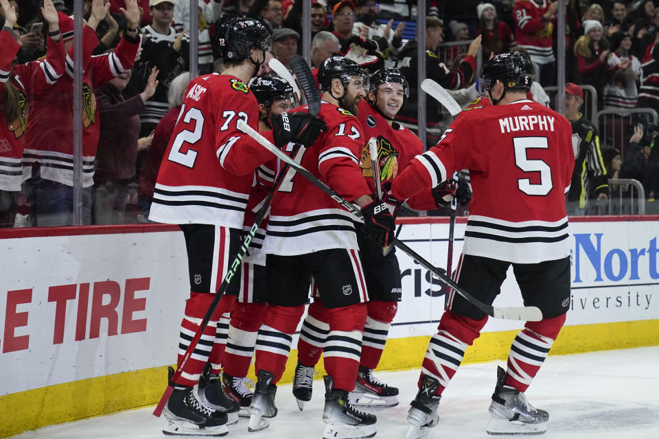 Chicago Blackhawks defenseman Alex Vlasic, center Connor Bedard, left wing Nick Foligno, center Philipp Kurashev and defenseman Connor Murphy, from left, celebrate Bedard's goal against the Winnipeg Jets during the first period of an NHL hockey game Wednesday, Dec. 27, 2023, in Chicago. (AP Photo/Erin Hooley)