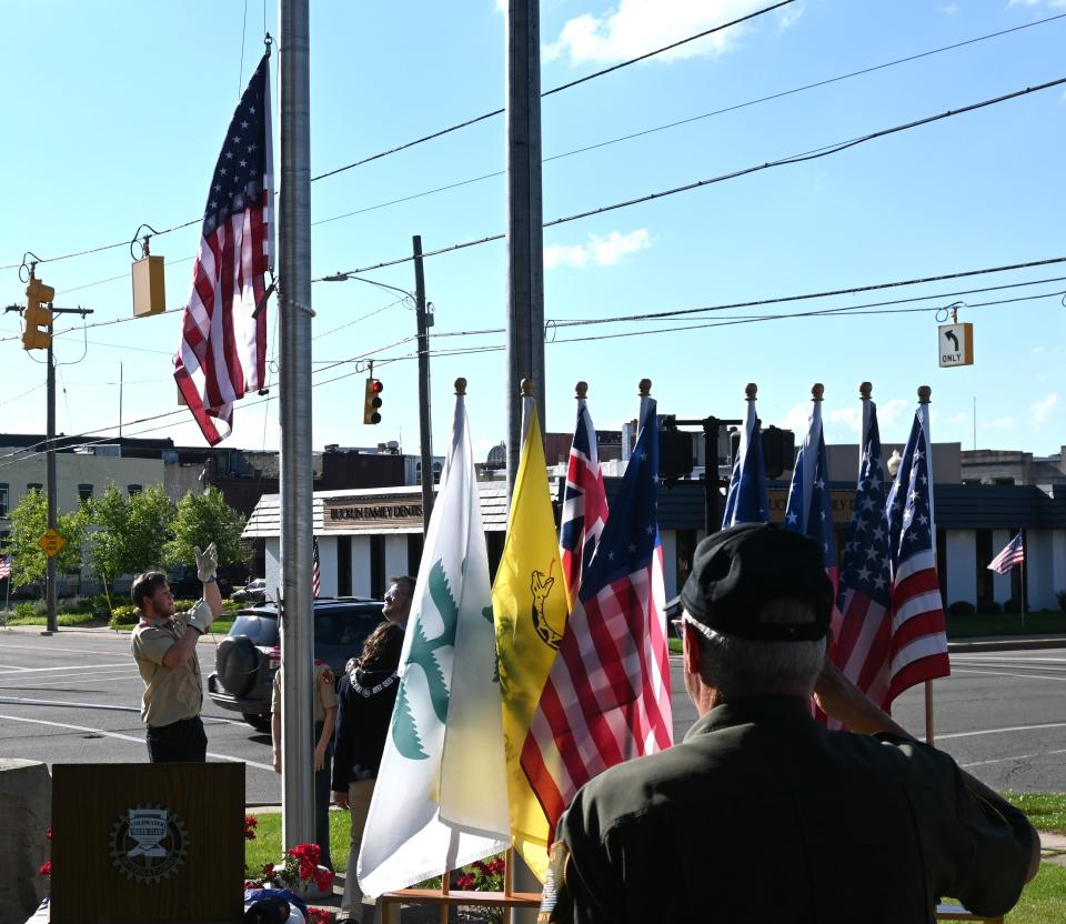 Boy Scouts raise the American Flag in front of a display of all American Flags from pre-Revolutionary War to our current flag in front of the Coldwater Elks Friday celebrating Flag Day.