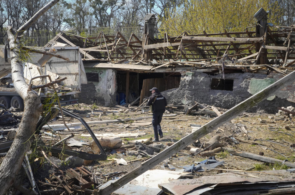 A police officer inspects a destroyed area following a Russian missiles attack on Thursday in Fastov, south of Kyiv, Ukraine, Friday, April 29, 2022. (AP Photo/Efrem Lukatsky)