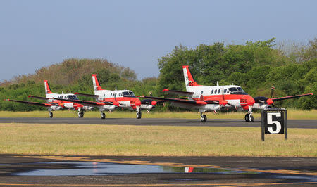 Three units of Beechcraft TC90 aircraft from the Japan Ministry of Defense (JMOD) taxi down a runway upon arrival for a transfer ceremony of the aircrafts to the Philippine Navy at the Naval Air Group (NAG) headquarters in Sangley Point, Cavite city, south of Manila, Philippines March 26, 2018. REUTERS/Romeo Ranoco