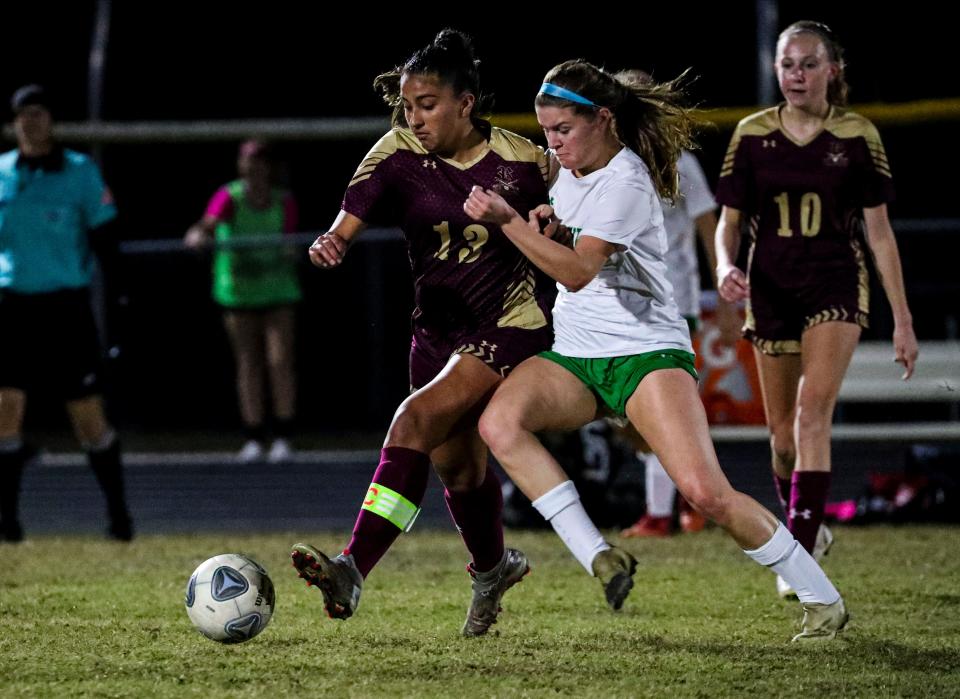Fort Myers' Samantha Degen tries to take the ball from Riverdale's Leah Villafuerte. Action from the Fort Myers at Riverdale girls soccer playoff game. Fort Myers won 3-0. 