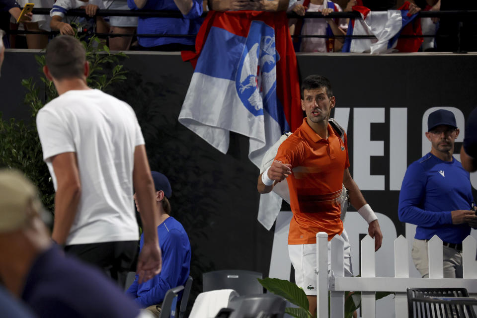 Serbia's Novak Djokovic speaks to his coaches as he heads to the locker room after winning the 2nd set against USA's Sebastian Korda during the final of the Adelaide International tennis tournament in Adelaide, Australia, Sunday, Jan. 8, 2023. (AP Photo/Kelly Barnes)
