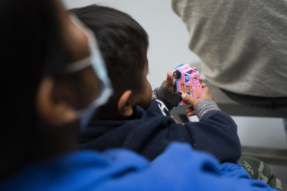 Migrants listen to Father Jose Machado, a visiting priest from Wichita, during a Mass at Kino Border Initiative on Wednesday, Dec. 21, 2022, in Nogales, Sonora, Mexico. Title 42 was scheduled to end on Dec. 21, but was granted a stay by the U.S. Supreme Court.