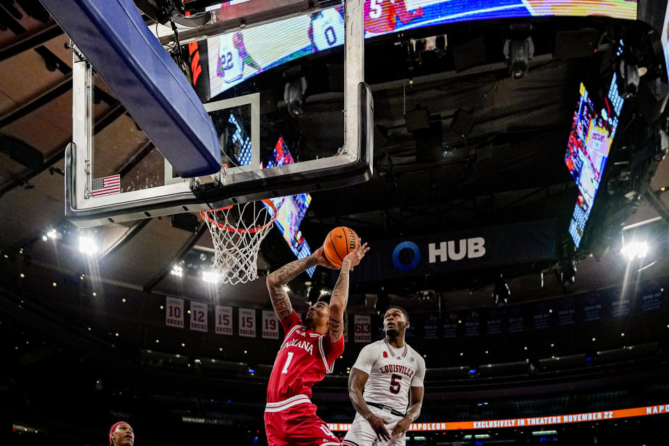 Indiana center Kel'el Ware (1) takes a shot over Louisville forward Brandon Huntley-Hatfield (5) in an NCAA college basketball game in the Empire Classic tournament in New York, Monday, Nov. 20, 2023. (AP Photo/Peter K. Afriyie)
