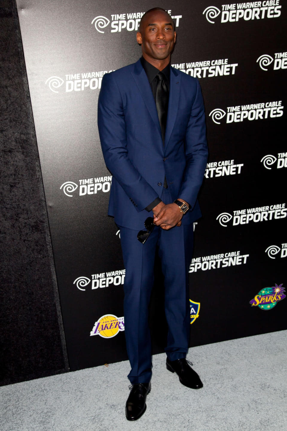 Kobe knows how to rock a suit of any color — especially this dark blue one with blacked-out accessories. (Photo: Getty Images)