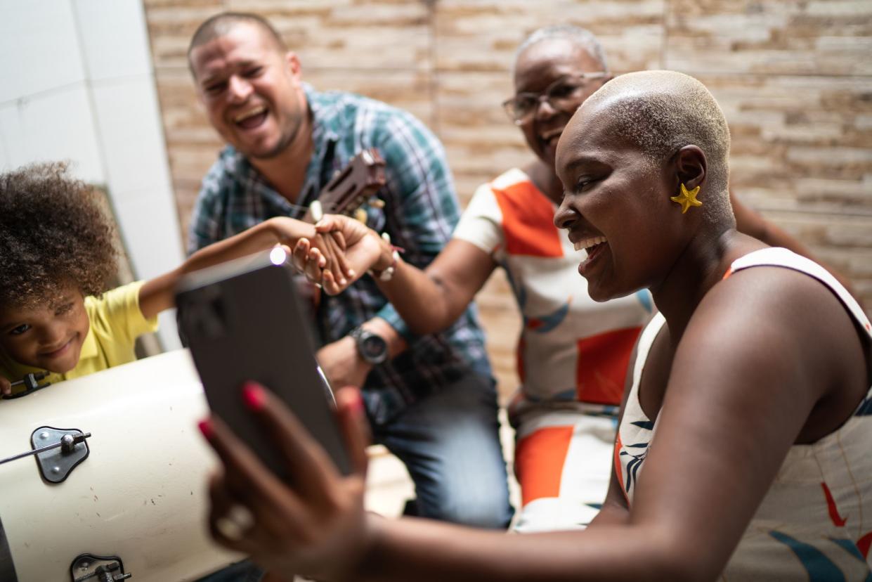 Family on a video chat while playing music at home - video chat