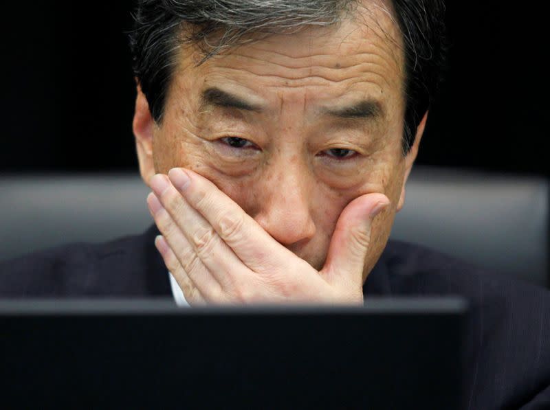 FILE PHOTO: Kurokawa, head of parliamentary committee investigating causes of Fukushima accident, looks at laptop monitor during a news conference in Tokyo