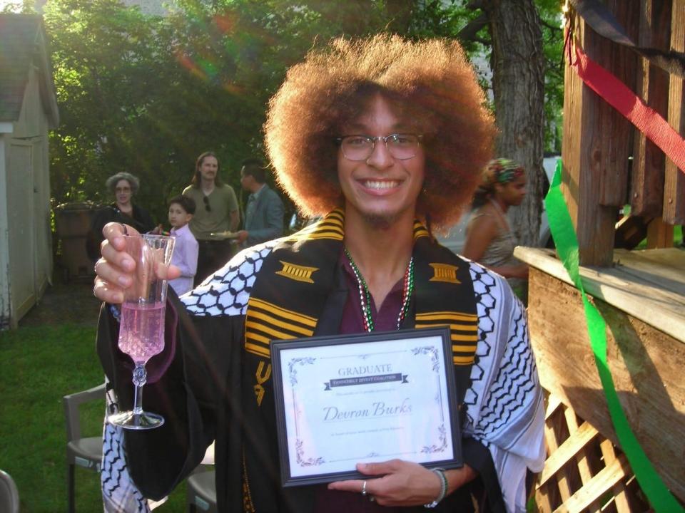 Devron Burks, 21, stands with a mock-diploma after being expelled from Vanderbilt University following a protest in which students occupied an administration building. Burks, whose high school graduation was canceled because of COVID, has appealed the expulsion.