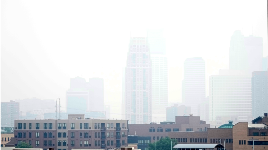 Haze envelopes the Minneapolis skyline from smoke drifted over from the wildfires in Canada, Wednesday, June 14, 2023, in Minneapolis. An air quality alert has been issued for some parts of Minnesota. (AP Photo/Abbie Parr)