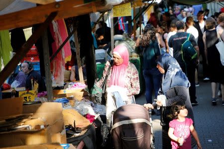 People visit a market in Berlin's Kreuzberg district, Germany, August 19, 2016. Picture taken August 19, 2016. REUTERS/Axel Schmidt