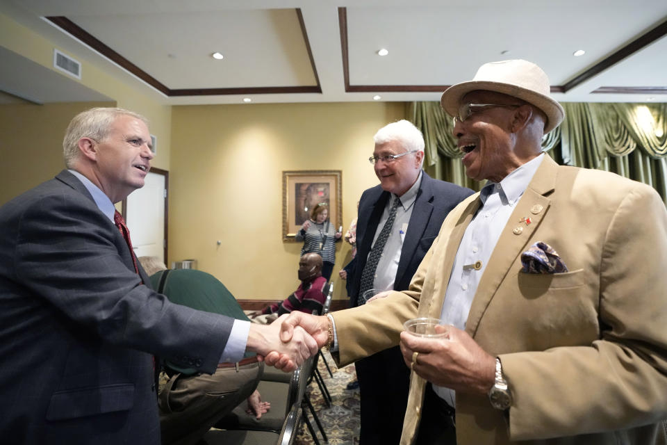 Democratic nominee for governor, Brandon Presley, current Mississippi Public Service Commissioner for the Northern District, left, shakes the hand of Rev. Clifton Marvel of the Greater Macedonia Baptist Church, right, during a meeting with supporters, Oct. 19, 2023, in Natchez, Miss. Presley faces Mississippi Republican Gov. Tate Reeves, who is seeking reelection on Nov. 7. (AP Photo/Rogelio V. Solis)