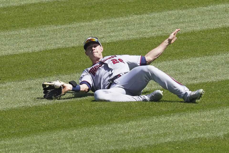 Minnesota Twins' Max Kepler is unable to catch a broken bat fly ball from Chicago White Sox's Yoan Moncada during the third inning of a baseball game Thursday, May 13, 2021, in Chicago. (AP Photo/Charles Rex Arbogast)