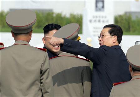 North Korean politician Jang Song Thaek (R) gestures next to North Korean leader Kim Jong Un (L) as they attend a commemoration event at the Cemetery of Fallen Fighters of the Korean People's Army (KPA) in Pyongyang, as part of celebrations ahead of the 60th anniversary marking the end of the 1950-53 Korean War, in this July 25, 2013 file photo. REUTERS/Jason Lee/Files