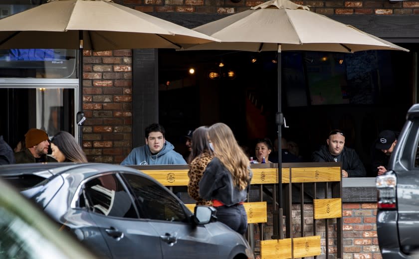 REDLANDS, CA - MARCH 14, 2021: Unmasked customers fill the outdoor seating at a local bar and restaurant on the first day San Bernardino County moved to the Red Tier allowing indoor seating at a limited capacity on March 14, 2021 in Redlands, California.(Gina Ferazzi / Los Angeles Times)
