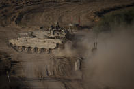 Israeli soldiers move on the top of a tank near the Israeli-Gaza border, as seen from southern Israel, Saturday, June 29, 2024. (AP Photo/Leo Correa)