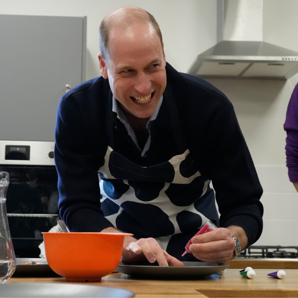  Prince William, Prince Of Wales smiles as he looks up while decorating biscuits during his visit to WEST, a new OnSide Youth Zone WEST on March 14, 2024 in London, England. 