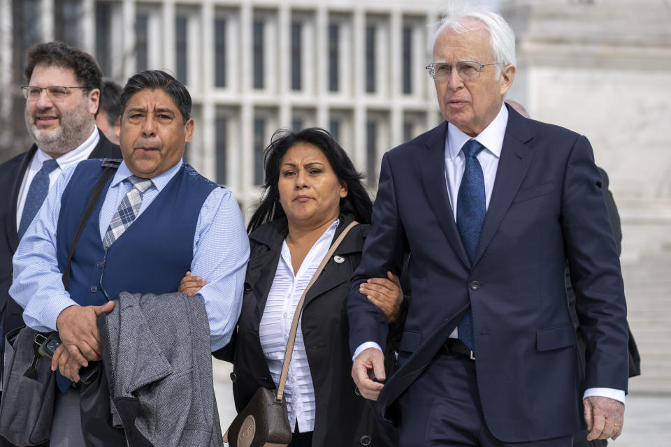 Attorney Eric Schnapper, right, walks with Beatriz Gonzalez, second from right, the mother of 23-year-old Nohemi Gonzalez, a student killed in the Paris terrorist attacks, and stepfather Jose Hernandez, outside the Supreme Court,Tuesday, Feb. 21, 2023, in Washington. A lawsuit against YouTube from the family of Nohemi Gonzalez was argued at the Supreme Court. (AP Photo/Alex Brandon)