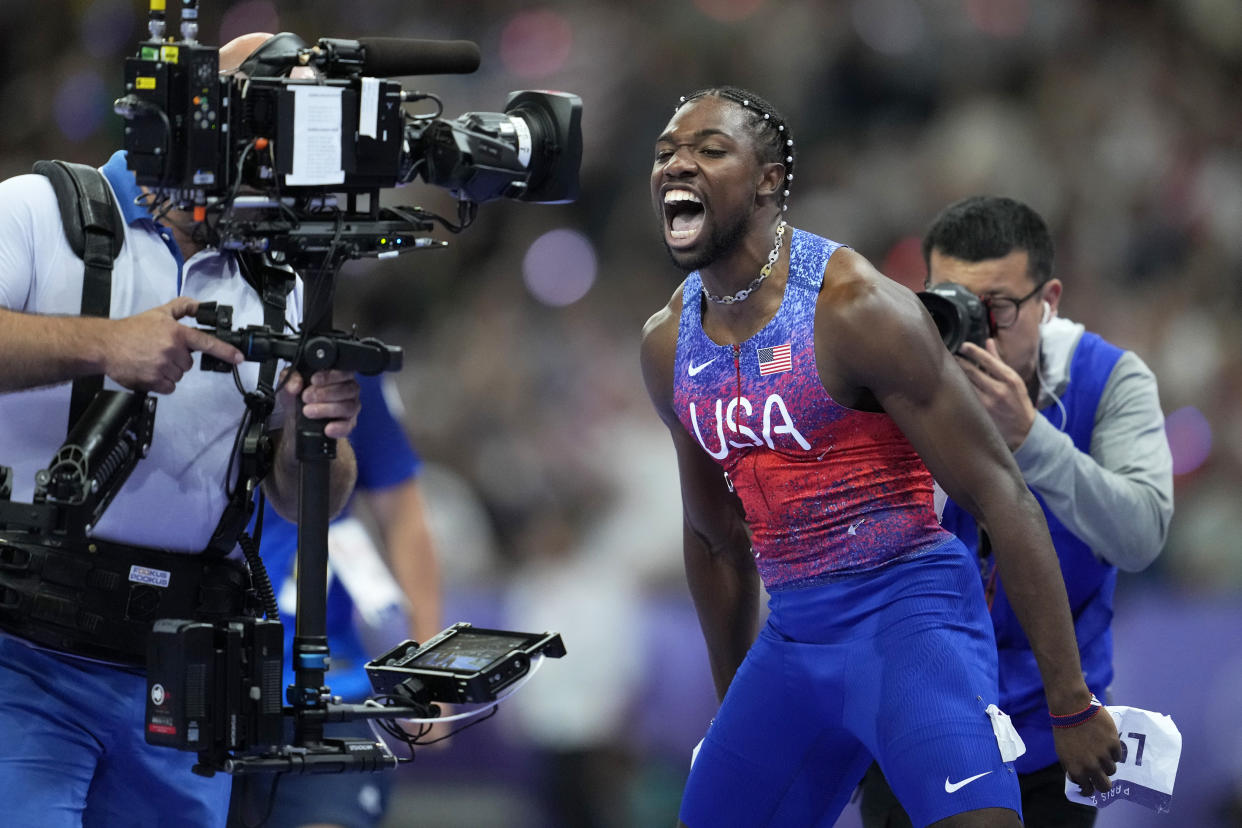 Noah Lyles, of the United States, screams at a television camera as he celebrates winning the gold medal in the men's 100-meter final at the Summer Olympics on Sunday. 