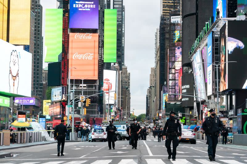 New York City police officers stand guard after a shooting incident in Times Square, New York