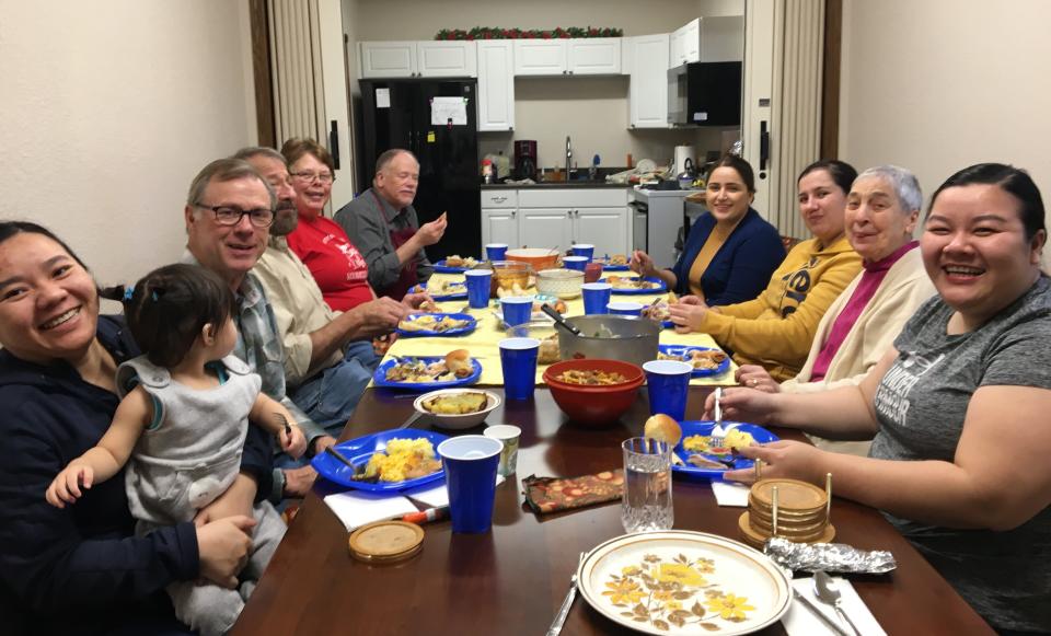 Glacial Lakes Multicultural Center volunteers share the American tradition of a Thanksgiving meal with English as a Second Language students in 2019.