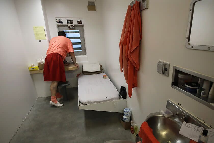 An inmate looks out a window in his solitary confinement cell at the Main Jail in San Jose.