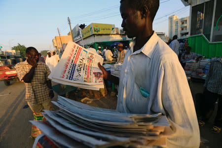 A vender carries news papers in Nyala market, during Sudanese President Omar al-Bashir visit to the war-torn Darfur region, in Nyala, Darfur, Sudan September 19, 2017. REUTERS/Mohamed Nureldin Abdallah