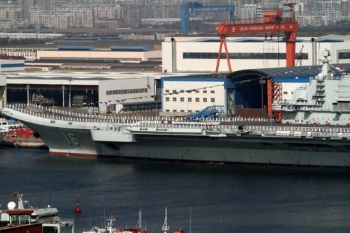 China's first aircraft carrier, the Liaoning sits berthed at the naval base in Dalian, northeast China's Liaoning province. The former Soviet ship, bought from Ukraine and refurbished, entered service on September 25, according to the defence ministry in Beijing