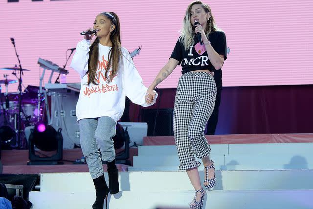 <p>Kevin Mazur/One Love Manchester/Getty </p> Ariana Grande and Miley Cyrus