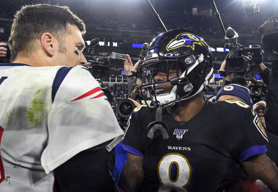 Tom Brady, left, told Lamar Jackson he's a big fan of the young quarterback's play.  (Mark Goldman/Getty Images)