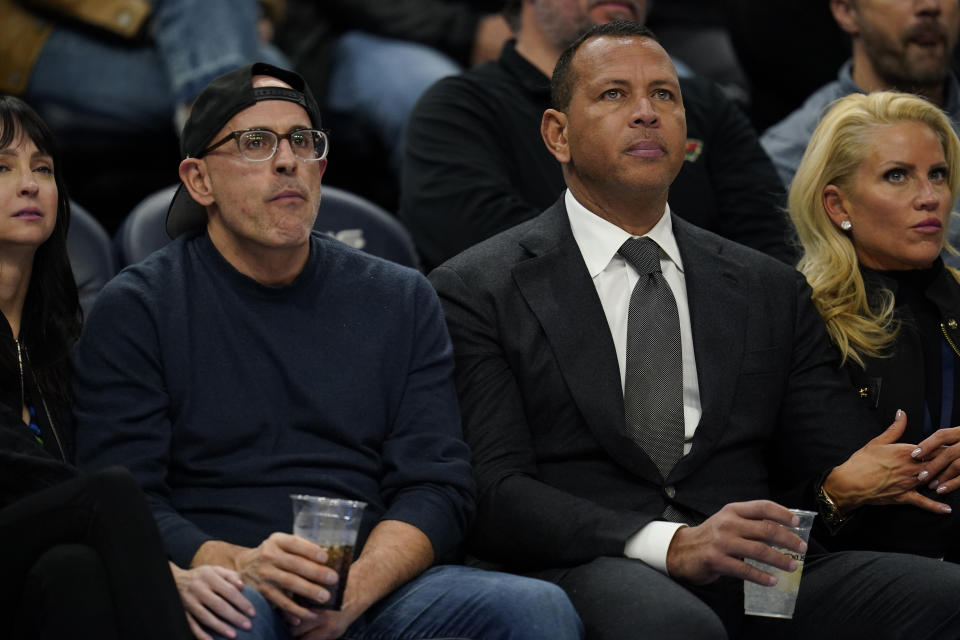 FOILE - Minnesota Timberwolves owners Marc Lore, left, and Alex Rodriguez watch during the first half of an NBA basketball game between the Minnesota Timberwolves and Phoenix Suns, Friday, Jan. 13, 2023, in Minneapolis. The ownership transfer of the Timberwolves slammed to a halt when Glen Taylor declared on Thursday, March 28, 2024, he won't take the final step of his drawn-out $1.5 billion deal to hand Marc Lore and Alex Rodriguez the majority stake because they didn't meet all of the deadlines in the sale conditions. (AP Photo/Abbie Parr, File)