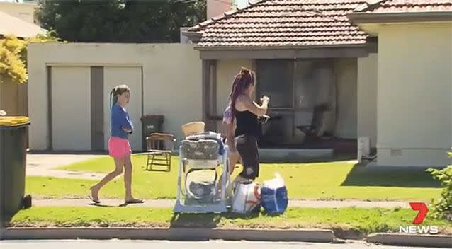 Nieghbours walk past the damaged Lockleys home. Source: 7 News