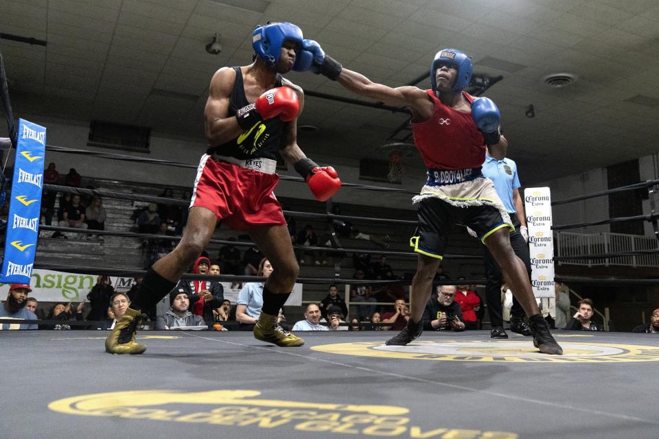 Theon Davis, 21, right, fights Kameron Powell in a 176-pound quarter-final boxing match at the Chicago Golden Gloves tournament Thursday, March 16, 2023, at Cicero Stadium in Cicero, Ill. Davis, who trains out of Garfield Park Boxing Gym in Chicago, won the bout and advanced to the finals. (AP Photo/Erin Hooley)