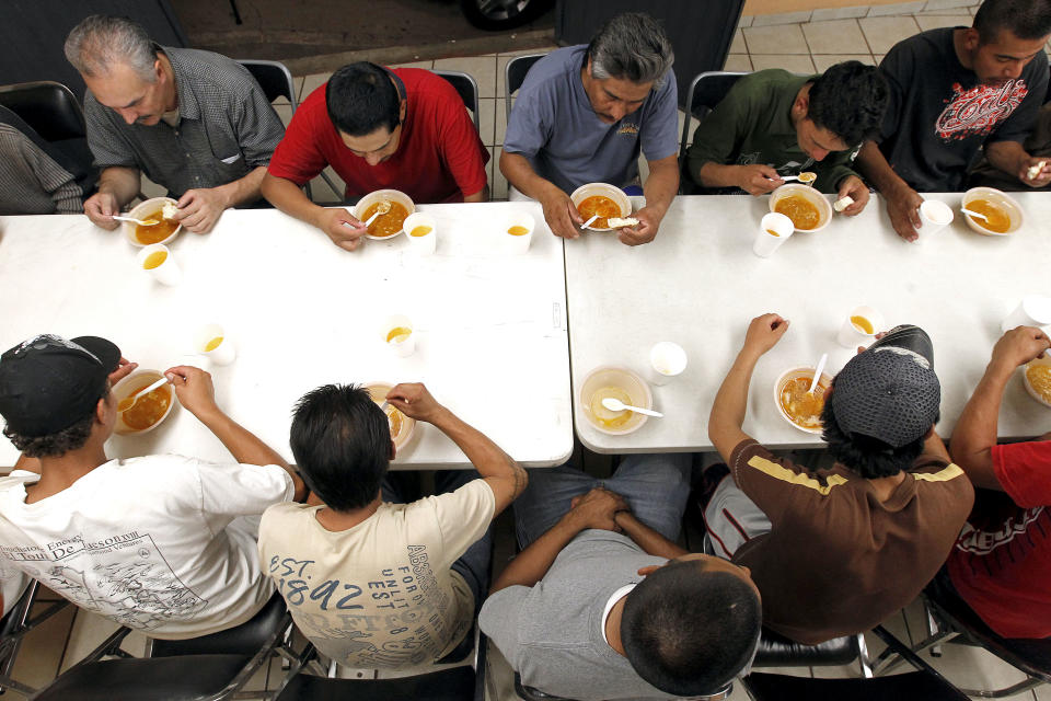 Dozens of men, many of them Mexican citizens, eat a modest dinner at a well known immigrant shelter, as many are making tough decisions on whether to try their luck at trying to make it to the United States, by illegally crossing the border, Thursday, Aug. 9, 2012, in Nogales, Mexico. The U.S. government has halted flights home for Mexicans caught entering the country illegally in the deadly summer heat of Arizona's deserts, a money-saving move that ends a seven-year experiment that cost taxpayers nearly $100 million.(AP Photo/Ross D. Franklin)