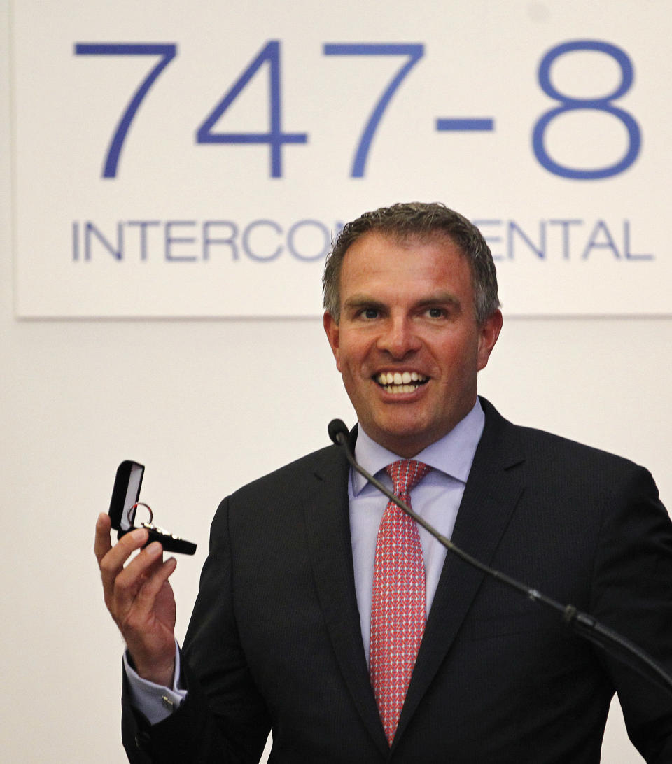 Lufthansa CEO Carsten Spohr smiles as he holds the keys to his new plane after delivery by Boeing of the first 747-8 Intercontinental Tuesday, May 1, 2012, in Everett, Wash. Lufthansa is the launch customer for the Intercontinental and will start service with the airplane between Frankfurt, Germany and Washington, D.C. The 747-8 Intercontinental is a stretched, updated version of the iconic 747 and is expected to bring double-digit improvements in fuel burn and emissions over its predecessor, the 747-400, and generate 30 percent less noise. Boeing delivered the first 747-8 Intercontinental to a private customer in February, more than a year after originally planned. (AP Photo/Elaine Thompson)