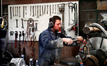 Factory worker Tom MacKay operates the lathe to make curling stones at Kays Factory in Mauchline, Scotland, Britain, January 11, 2018. REUTERS/Russell Cheyne