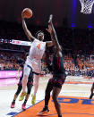 Illinois' Justin Harmon drives to the basket as Rutgers' Clifford Omoruyi defends during the second half of an NCAA college basketball game, Sunday, Jan. 21, 2024, in Champaign, Ill. (AP Photo/Charles Rex Arbogast)