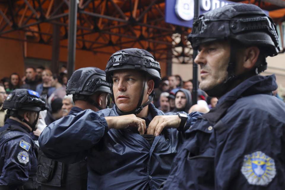 Kosovo police officers guard municipal building in the town of Zvecan, Kosovo, Friday, May 26, 2023. Small groups of ethnic Serbs in northern Kosovo on Friday clashed with police while trying to block the entrance of municipal buildings to prevent recently-elected officials from entering them, according to local media. (AP Photo/Bojan Slavkovic)