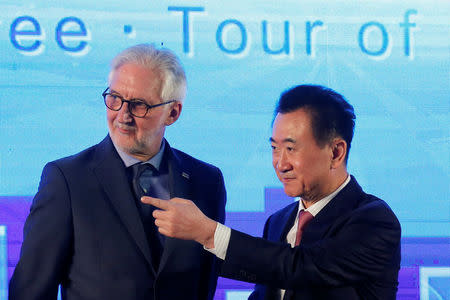 Wanda Group Chairman Wang Jianlin (R) and President of the Union Cycliste Internationale (UCI) Brian Cookson attend a signing ceremony for a China hosted UCI world tour cycling race in Beijing, China, December 1 , 2016. REUTERS/Thomas Peter